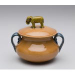 Thumbnail image for pot & lid, decorative, amber colour with navy blue rim & handles, with a small three-dimensional elephant as a knop or handle on the lid in olive green, pot & lid highly glazed inside & out